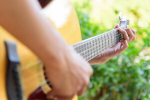 playing acoustic guitar in the park