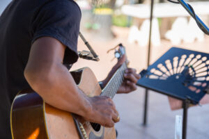hipster playing a old wood guitar in happy moment with blur background