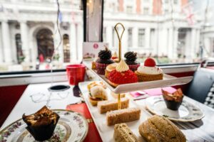 Delightful afternoon tea setup with pastries and sandwiches in a London cafe.